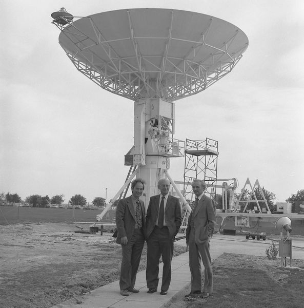 Three Directors under the IRAS Dish: Geoff Manning (new Director of Rutherford Appleton Lab), Godfrey Stafford (out-going Director of Rutherford Lab) and John Houghton (out-going Director of Appleton Lab)