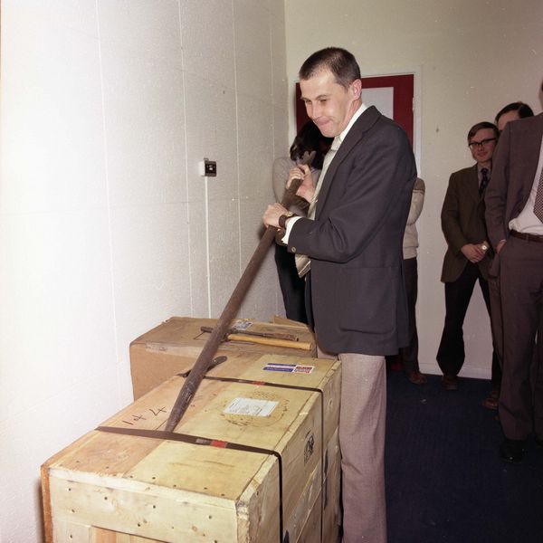 Bob Hopgood uses an ICL provided crowbar to attack the wooden crate containing the first PERQ to arrive al RL on 21 January 1981