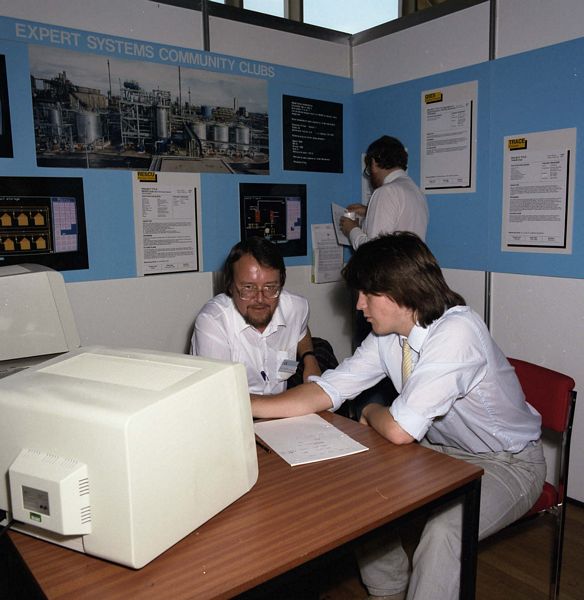 Gordon Ringland (left) at the Expert Systems Community Club Stand at the Alvey Conference, Sussex, 1986