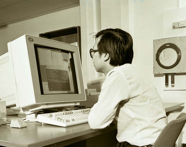 Francis Yeung viewing output on IBM 6150 Unix workstation The graphics program runs on the 6150 while the flood model program runs on the IBM 3090 vector processing mainframe.   The 3090 session is in the largest window of the 6150.